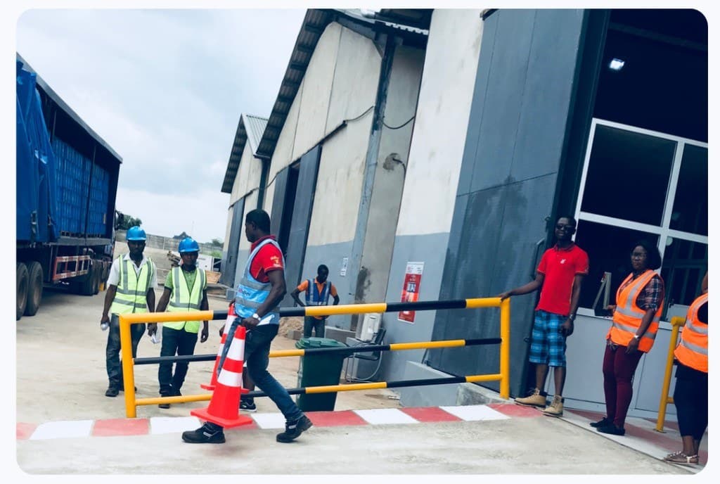 Workers at a warehouse loading dock with freight truck